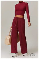 Burgundy quick drying fitness crop top and pants set with sneakers and handbag