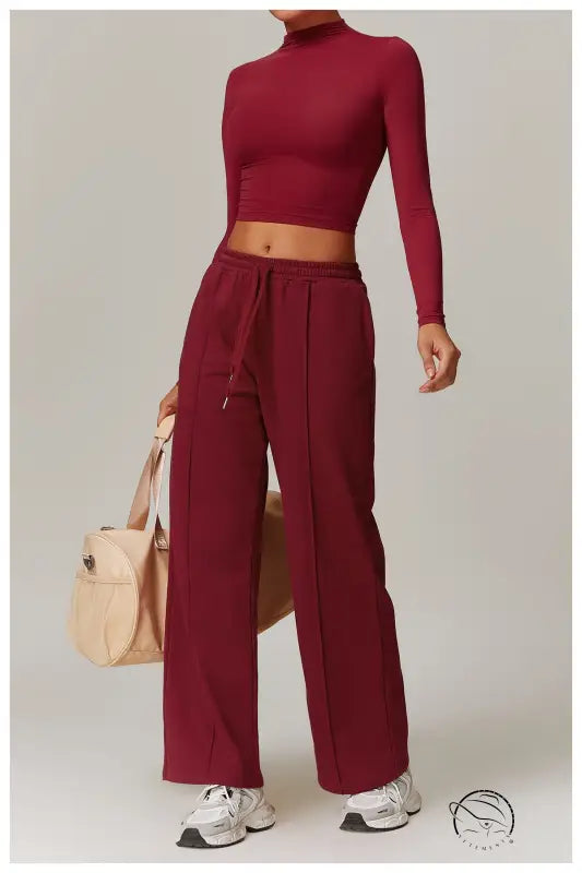 Burgundy quick drying fitness crop top and pants set with sneakers and handbag