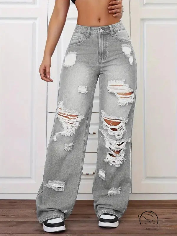 Gray ripped washed high-waist denim trousers with white stitching and black sneakers in langry fashion