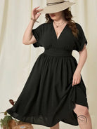 Plus-size woman in vacation high waist A-line black V-neck midi dress and hat