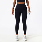 Black high-waisted athletic leggings paired with white sneakers for stylish yoga fashion