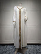 Elegant white and gold embroidered langry fashion dress on mannequin
