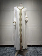 White and gold embroidered langry fashion dress on mannequin