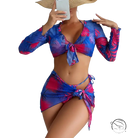 Four piece lace up swimsuit in vibrant blue and pink tropical leaves on red floral background