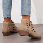 Beige suede daily ankle boots featuring triangular cutouts and stacked wooden heels