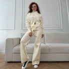 Langry cream satin tracksuit with high neck, drawstring waist, black sneakers