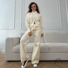 Langry fashion cream satin tracksuit with drawstring waist and high neck, black sneakers