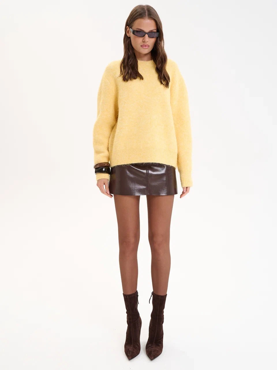 Winter wool alpaca oversized sweater with leather skirt and sunglasses