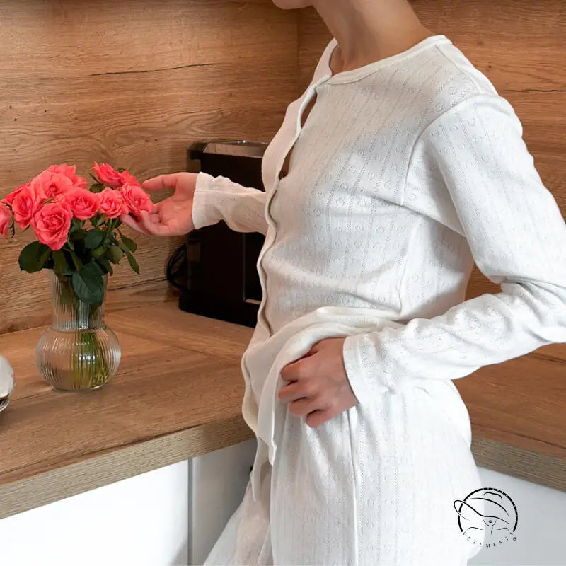 Person in white knitted jacquard pajamas with textured long-sleeved top and pants