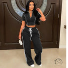 Black and white loose trousers with side stripes, drawstring waist, relaxed fit