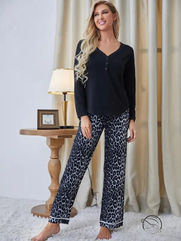 Black long-sleeved langry pajama top with leopard-print pants and white piping