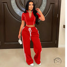 Red polyester tracksuit with white stripes, loose trousers and drawstring waistband