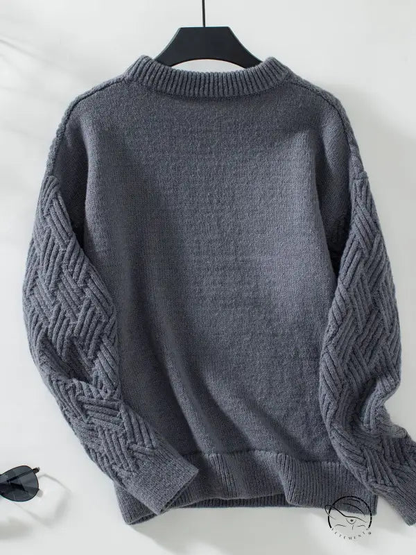 Charcoal gray crew neck cable knit sweater with textured sleeves