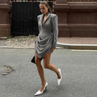 Slim deep V plunge neck Langry fashion blazer dress in gray with ruched detailing and white high heels
