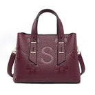 Langry fashion burgundy leather tote with gold hardware and S monogram