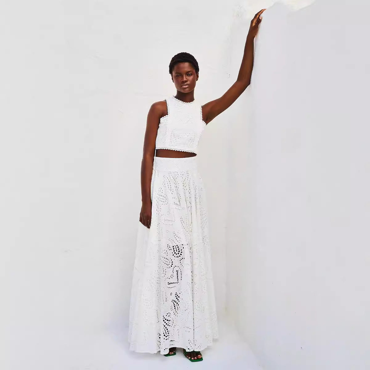 Woman in white eyelet crop top and maxi skirt, showcasing Langry fashion ملابس