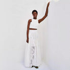 Woman in white eyelet crop top and maxi skirt, showcasing Langry fashion ملابس