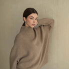 Beige oversized langry fashion turtleneck sweater with ribbed detailing