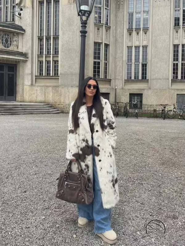Cozy faux fur long coat in cow print with brown and white spots