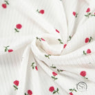 White ribbed langry cardigan with red rose embroidery and green stems