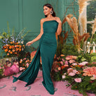 Elegant emerald green strapless evening gown with train, perfect for fashion-forward ملابس
