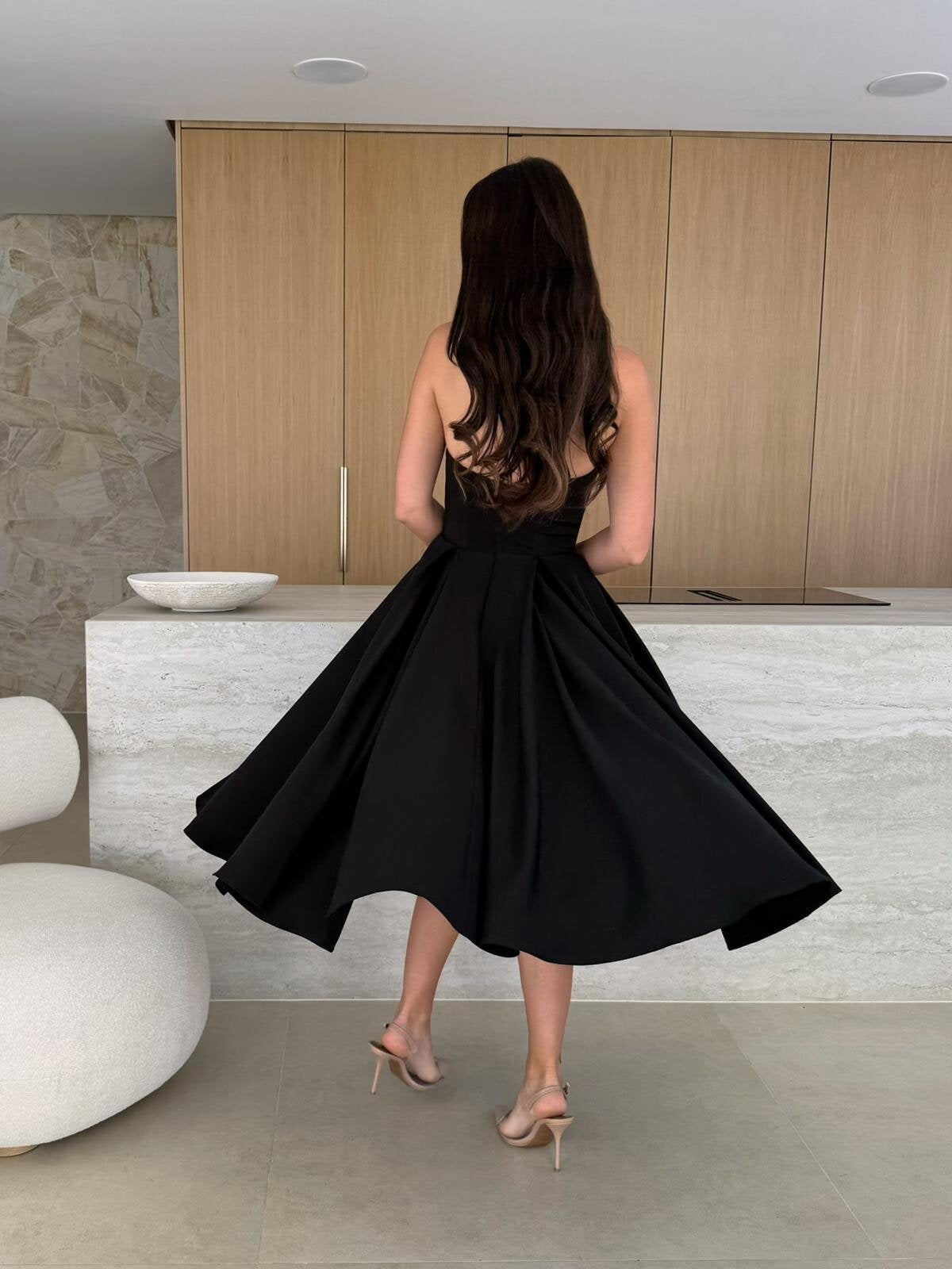 Woman in a black dress showcasing the Gorgeous Midi Dress, a stylish langry fashion ملابس choice