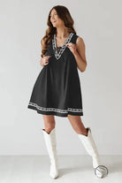 Beautiful embroidered vest denim dress in black with white trim and boots