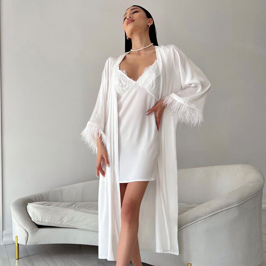 White silk robe with feather trim over a matching slip dress for luxurious homewear