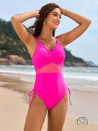 Stunning mesh swimsuit in hot pink with cutout details and side ties