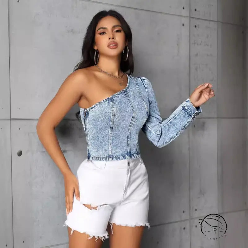 Woman in slim denim one-shoulder top and distressed white shorts