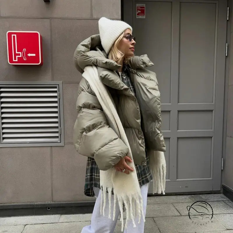 Woman in langry fashion cotton padded jacket with scarf and beanie
