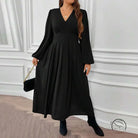 Woman in gorgeous large swing dress with V-neck, pleats, boots, clutch