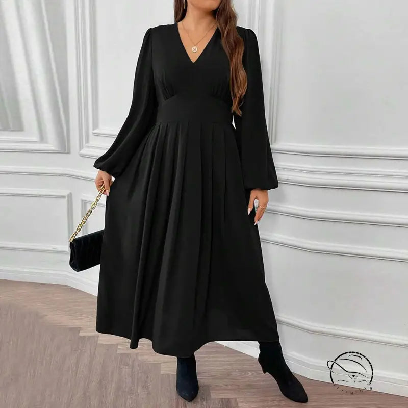 Woman in gorgeous large swing dress with V-neck, pleats, boots, clutch