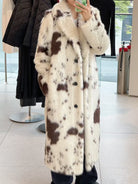 Cozy faux fur long coat with cow print, large buttons, and high collar