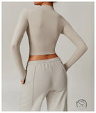 Quick drying fitness sports outerwear: beige cropped top and sweatpants rear view