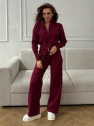 Langry fashion burgundy zip-up jumpsuit with wide-leg pants and white sneakers