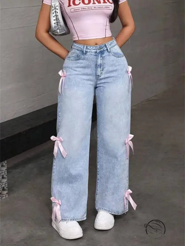 Light wash blue loose straight leg jeans with pink ribbon bows on sides
