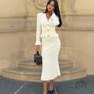 Woman in elegant classic dress and white knit skirt suit