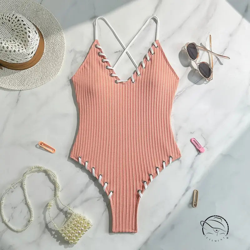Stunning matching sling swimwear in peach ribbed one-piece with criss-cross straps