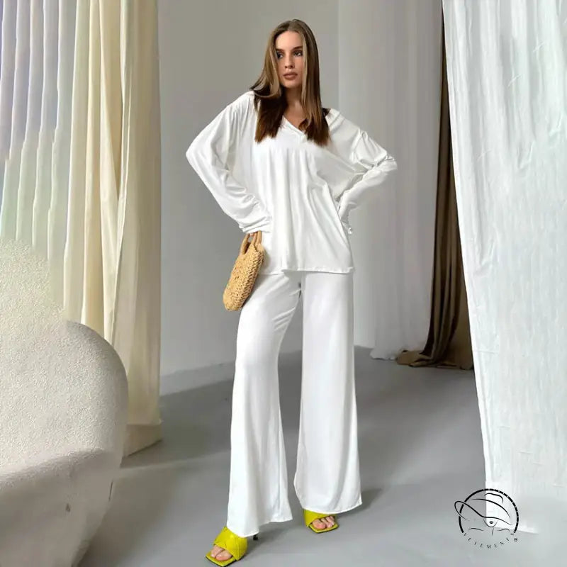 Woman in comfortable knitted pajamas with yellow heels and straw bag