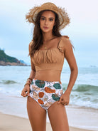 Two-piece Gorgeous Split Bikini featuring a brown ruched crop top and floral high-waisted bottoms