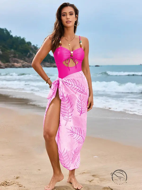 Pink one piece swimsuit with tropical leaf sarong
