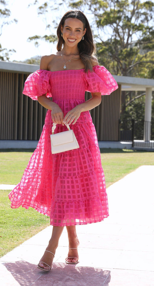 Woman in a pink off-the-shoulder Enchanting Lantern Sleeve Dress, a stunning fashion choice