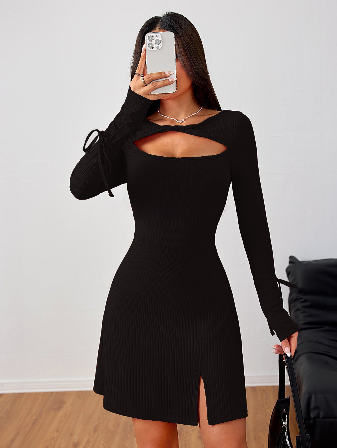 Black long-sleeved mini dress with cutout detail and side slit, perfect for trendy fashion ملابس