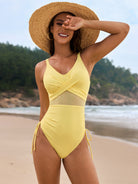 Yellow mesh-paneled one-piece swimsuit with side ties for stylish beach fashion