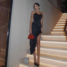 Strapless black evening gown with asymmetrical hem and side slit for elegant fashion