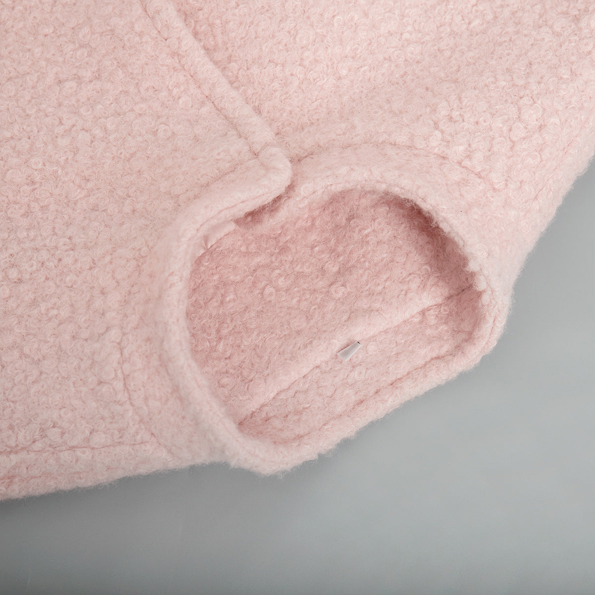 Close-up of pink fuzzy fabric sleeve on Pink Short Furry Coat for stylish cold-weather wear