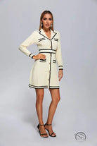 Cream-colored knitted classic dress with black trim and gold buttons
