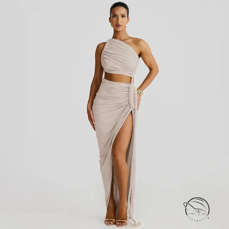 Stunning cutout lace pleated dress with beige one-shoulder crop top and high-slit skirt