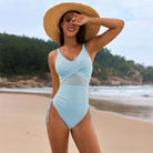 Light blue one-piece swimsuit with mesh cutouts and ties, stylish fashion for summer